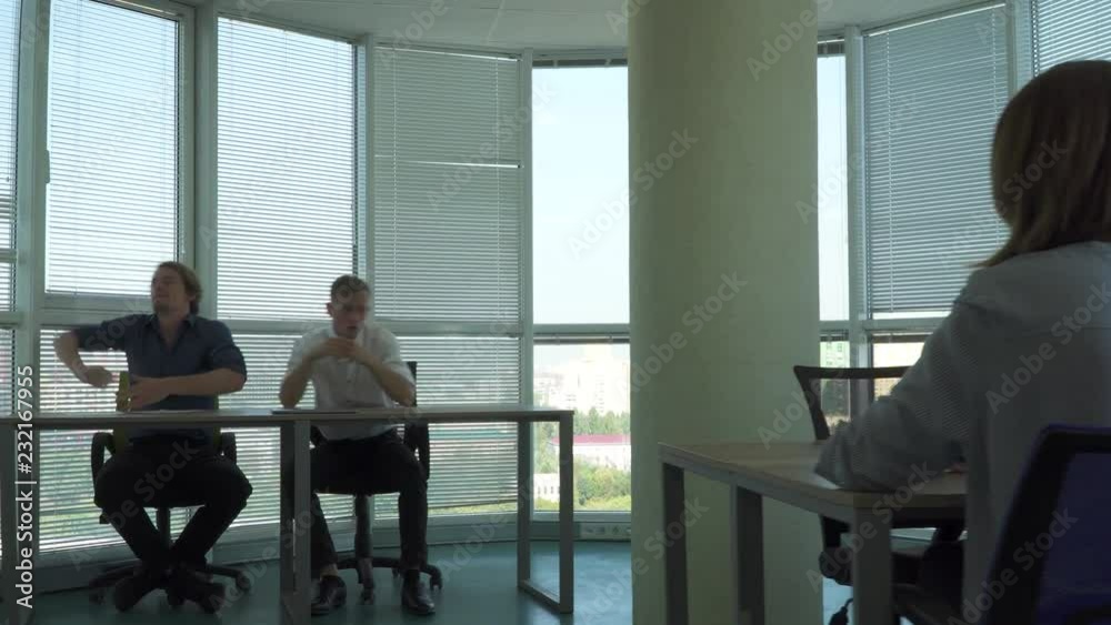 Two handsome guys and a girl work in a beautiful office Two handsome guys and a girl work in a beautiful office