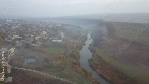 Beautiful sunrisw over river in rural area. Fog over small river. Mountains landscape. photo