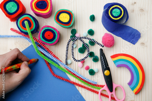 Hand Holding Pen on Desk with Art And Craft Supply 