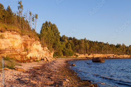 Limestone cliff on the coast of the Baltic sea. Sunset time and warm colors.