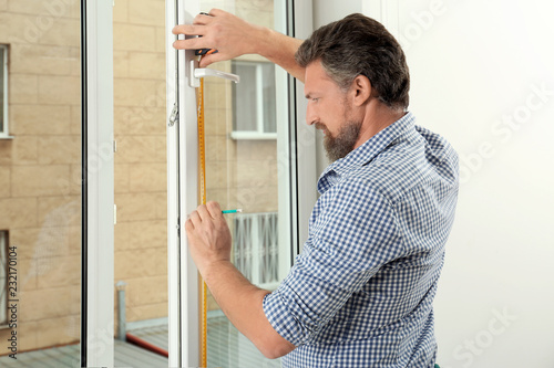 Man installing new modern window in house