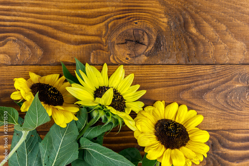 Fototapeta Naklejka Na Ścianę i Meble -  Decorative sunflowers on the wooden background