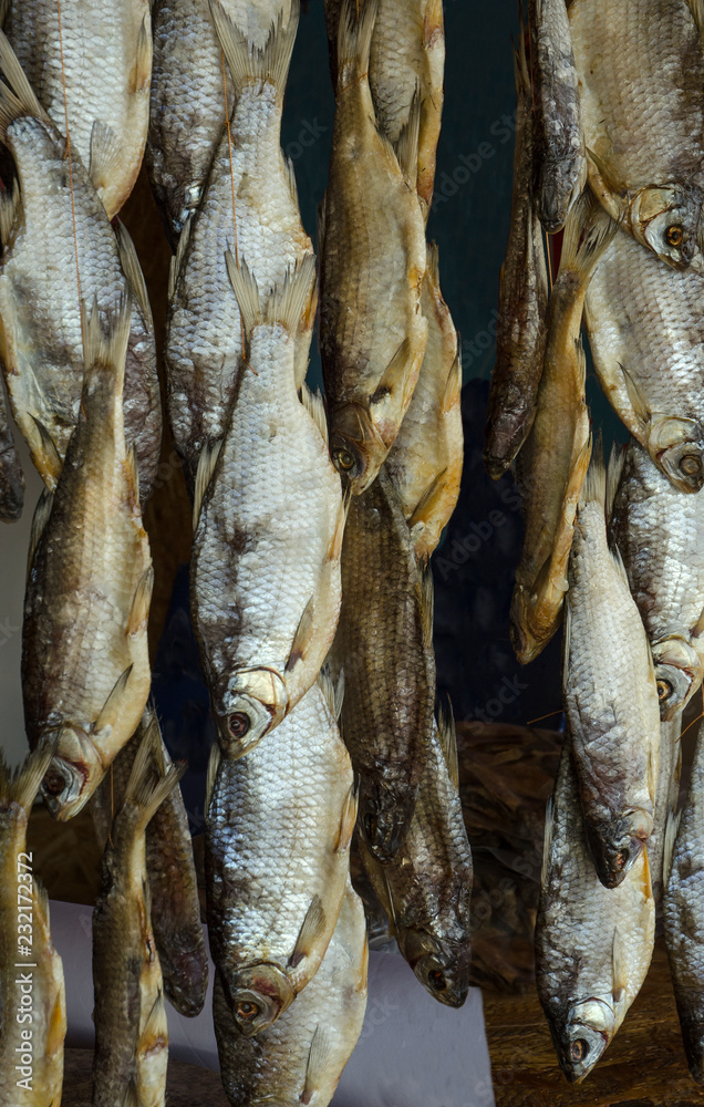 dried fish hanging on a rope