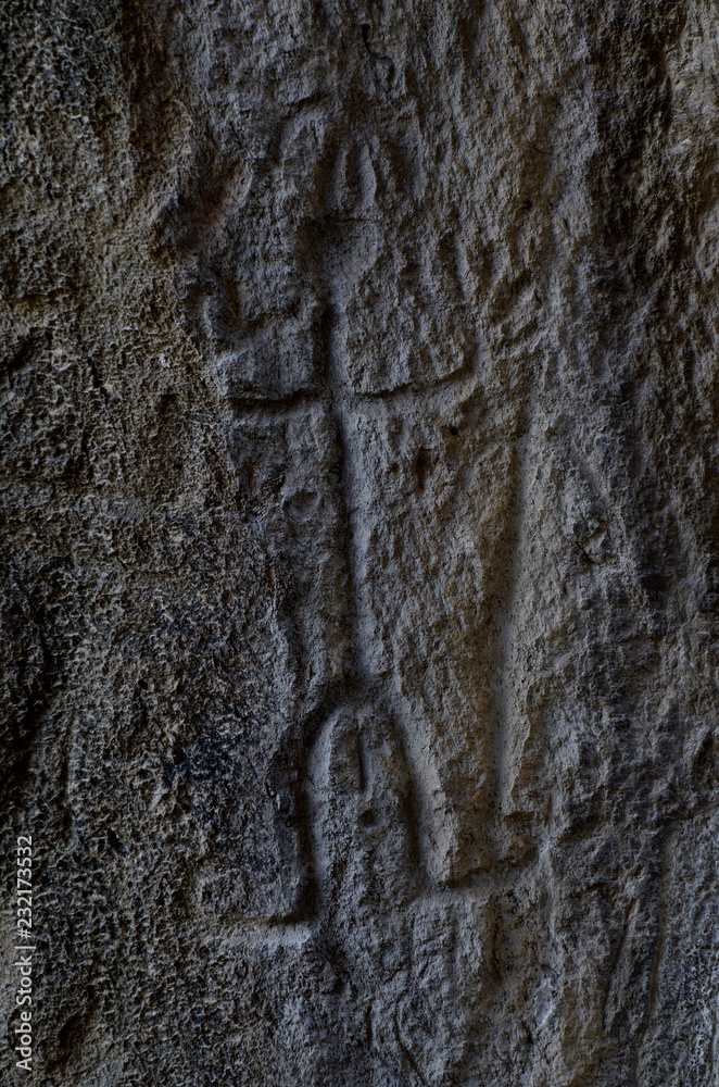 Obraz premium Neolithic rock paintings of Gobustan National Park, depicting dancing shaman holding spear in his hand, Azerbaijan,Caucasus,unesco heritage site