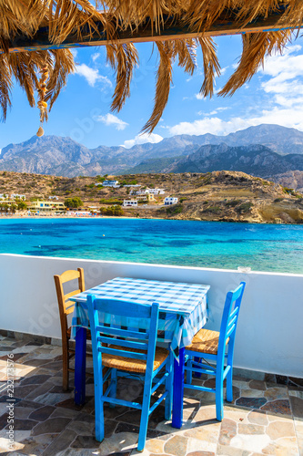 Terrace with table in traditional Greek tavern in Lefkos port on Karpathos island  Greece