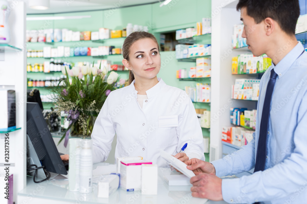 girl pharmacist is recommending medicine for man