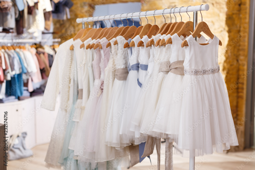 Kids white dresses on hangers