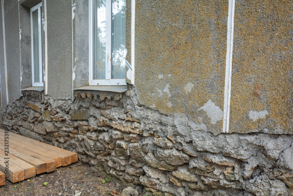 Collapsing base house. Old damaged wall of a saber house with a