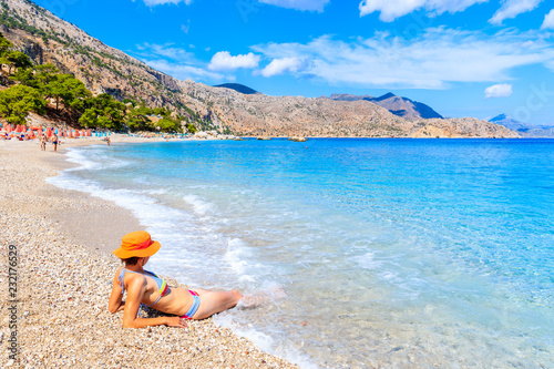 Fototapeta Naklejka Na Ścianę i Meble -  Young woman relaxing in water on Apella beach, Karpathos island, Greece