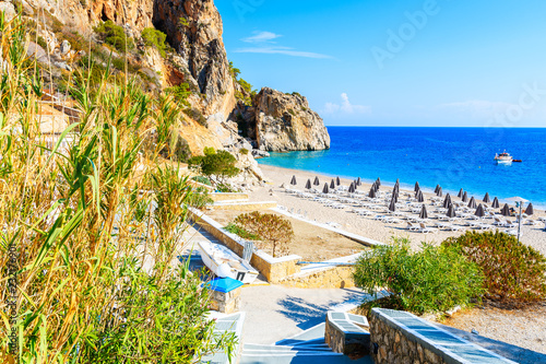 Walkway to amazing bay with beach in Kyra Pynagia village on sea coast of Karpathos island, Greece