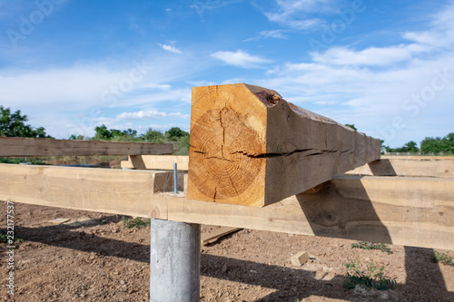 The pine board impregnated with an antiseptic on the frame basis of the house. Construction of the base of the A-type frame house.