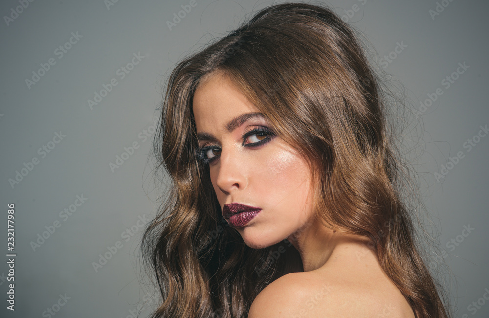 woman with fashion makeup and long curly hair. Beauty salon and hairdresser. Makeup cosmetics and skincare. Fashion portrait of woman. fashion girl with glamour makeup. Glamour fashion model woman with fashion makeup and long curly hair. Beauty salon and hairdresser. Makeup cosmetics and skincare. Fashion portrait of woman. fashion girl with glamour makeup. Glamour fashion model