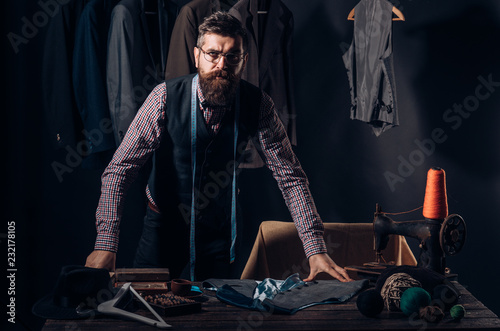 I love it. Bearded man tailor sewing jacket. business dress code. Handmade. suit store and fashion showroom. retro and modern tailoring workshop. sewing mechanization. Fashion and beauty