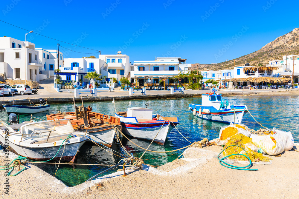 Fishing boats on turquoise sea water in Finiki port, Karpathos island, Greece