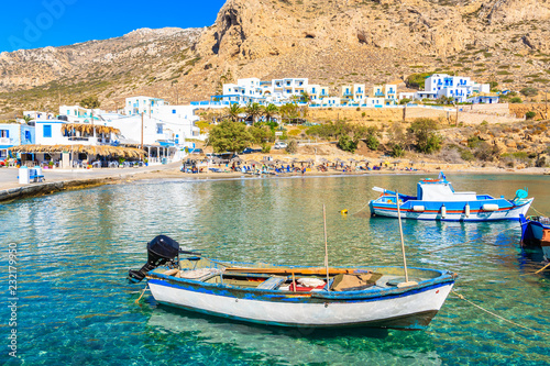 Fishing boats on turquoise sea water in Finiki port, Karpathos island, Greece