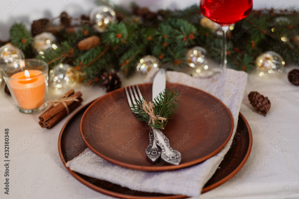 Table with Christmas decorations and garland, ware, green spruce branches