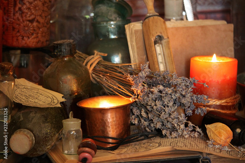 Fototapeta Naklejka Na Ścianę i Meble -  Antique Magic Book. Witchcraft Peacock feathers and candle background. Black candle Magic Ritual.