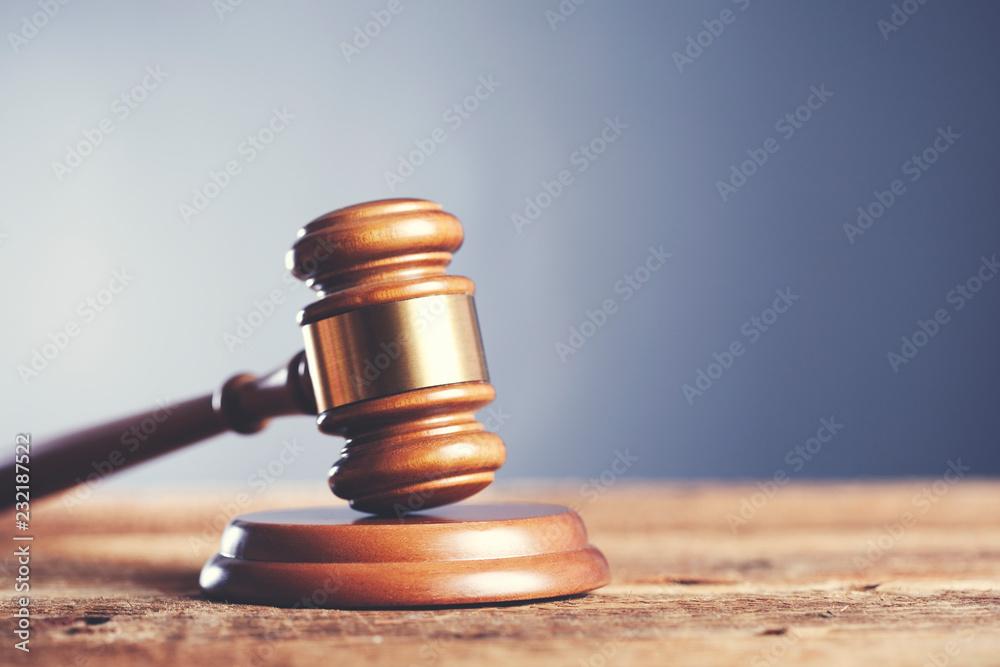 judge mallet on a wooden desk judge mallet on a wooden desk