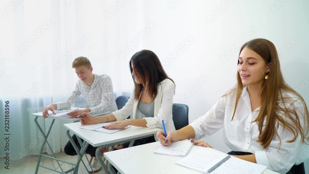 young smart girl from student group answering mentor's question in high school classroom. practice, learning, education, knowledge, development, growth concept
