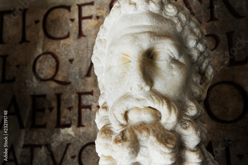 Bust of imperator Commodus in the Capitoline Museum in Rome. On the background ancient latin inscription. Rome, Italy photo