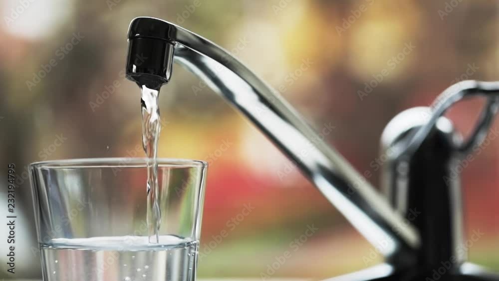 Glass is filled with fresh drinking water. Slow motion. Glass is filled with fresh drinking water. Slow motion.