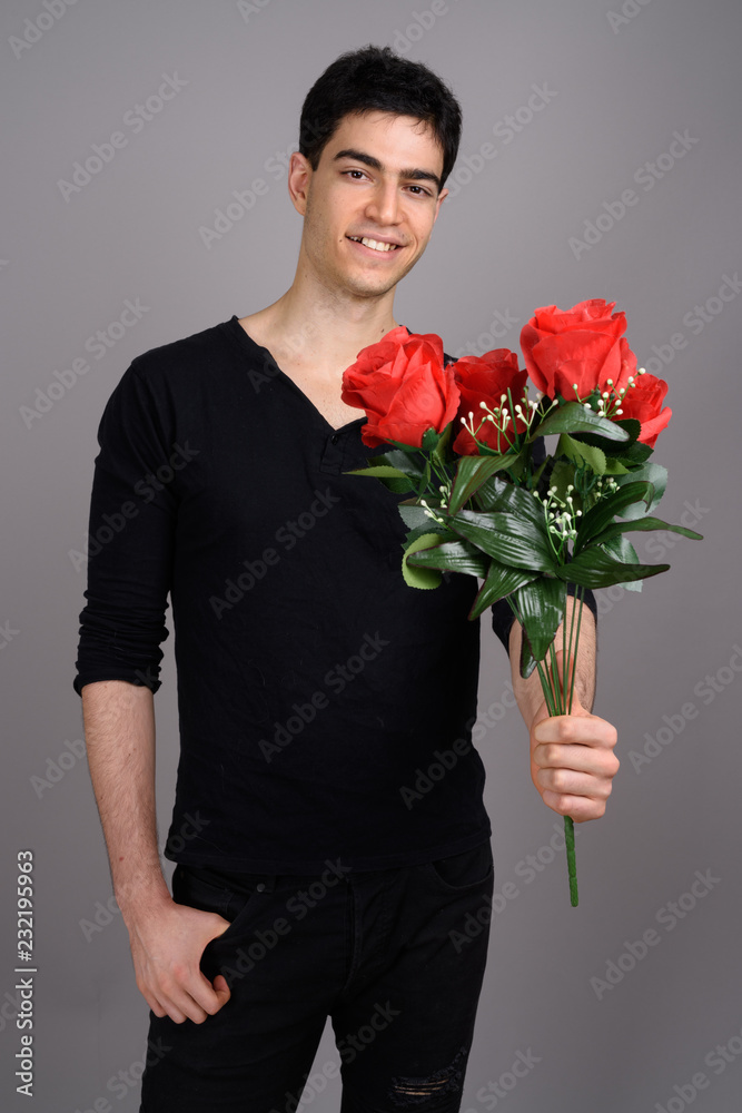 Portrait of young handsome man against gray background Portrait of young handsome man against gray background