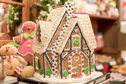 Gingerbread house decorated with icing and candy on display at a retail shop during Christmas holidays