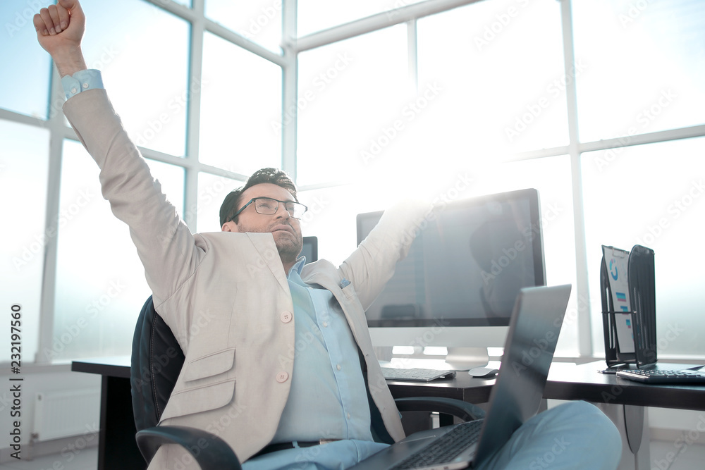 Fototapeta premium yawning businessman sitting in front of the Desk.
