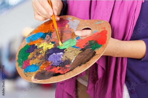 Fototapeta Naklejka Na Ścianę i Meble -  Artist paints a picture of oil paint brush in hand with palette