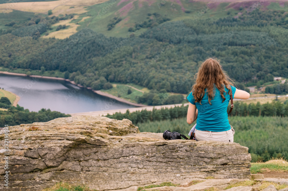 Young woman admiring the view at Ladybower Reservoir in the Peak District