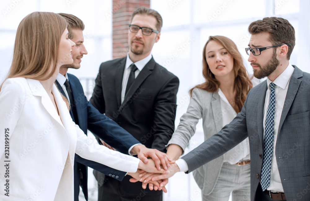 successful business team putting their palms togethe successful business team putting their palms togethe
