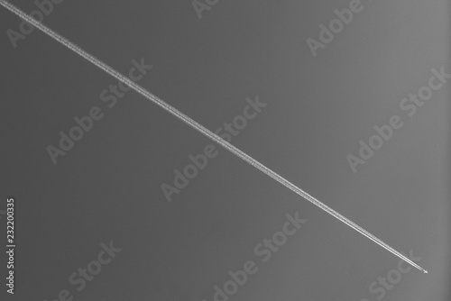 Airplane trail on the b&w background