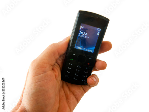 Wallpaper Mural SAO PAULO, BRAZIL - MAY 31, 2018 - Hand holding an old style cel phone with white background - disconnected unplugged no smartphone Torontodigital.ca