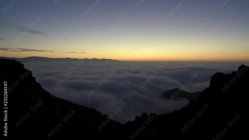 Above the clouds and fog dawn time lapse view towards of the San Fernando Valley area of Los Angeles, California. Taken from Rocky Peak in the Santa Susana Mountains. Above the clouds and fog dawn time lapse view towards of the San Fernando Valley area of Los Angeles, California. Taken from Rocky Peak in the Santa Susana Mountains.