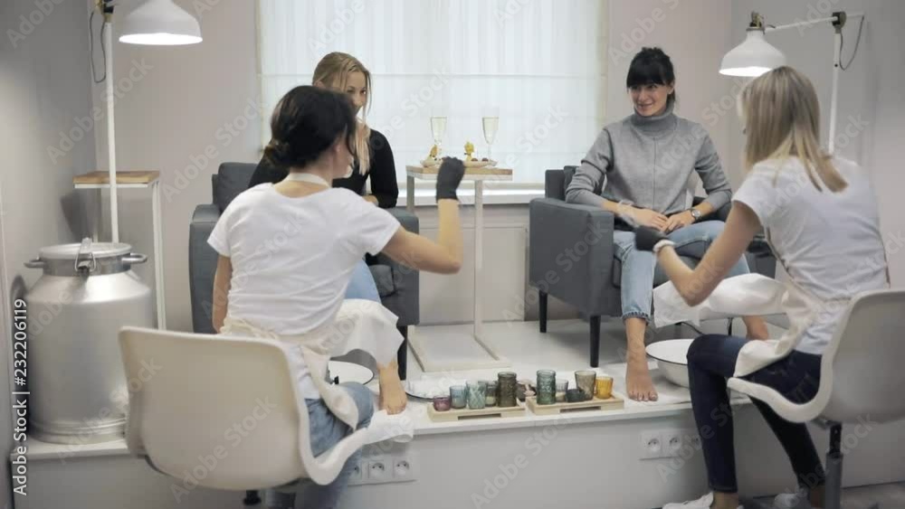 Two women enjoying feet massage in spa beauty salon Two women enjoying feet massage in spa beauty salon