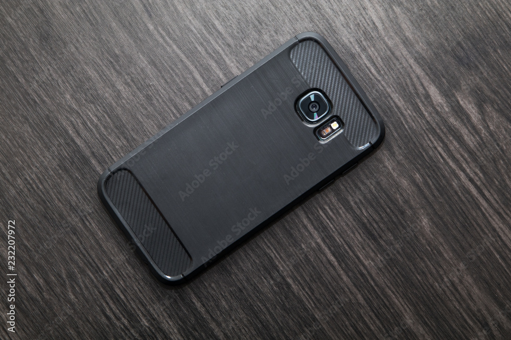 Black Mobile Phone With Camera and LED On Wood Table Black Mobile Phone With Camera and LED On Wood Table