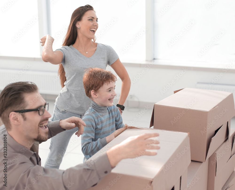 young family is having fun in a new apartment young family is having fun in a new apartment