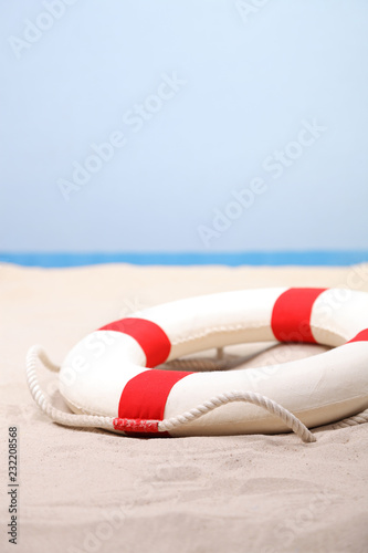 Lifebuoy on white sand