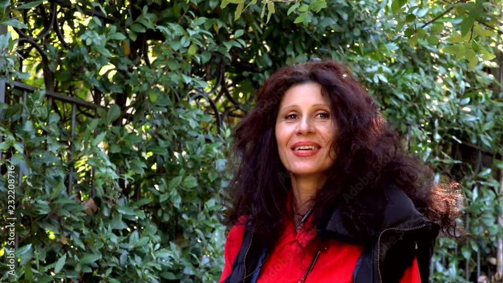 woman with long hair laughing in garden