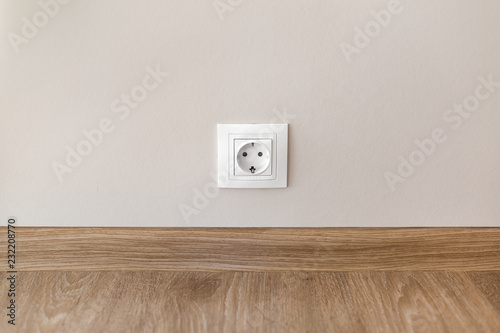 Electric socket mounted on wall at modern flat photo