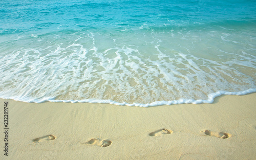 Human footprints on a sandy beach.
