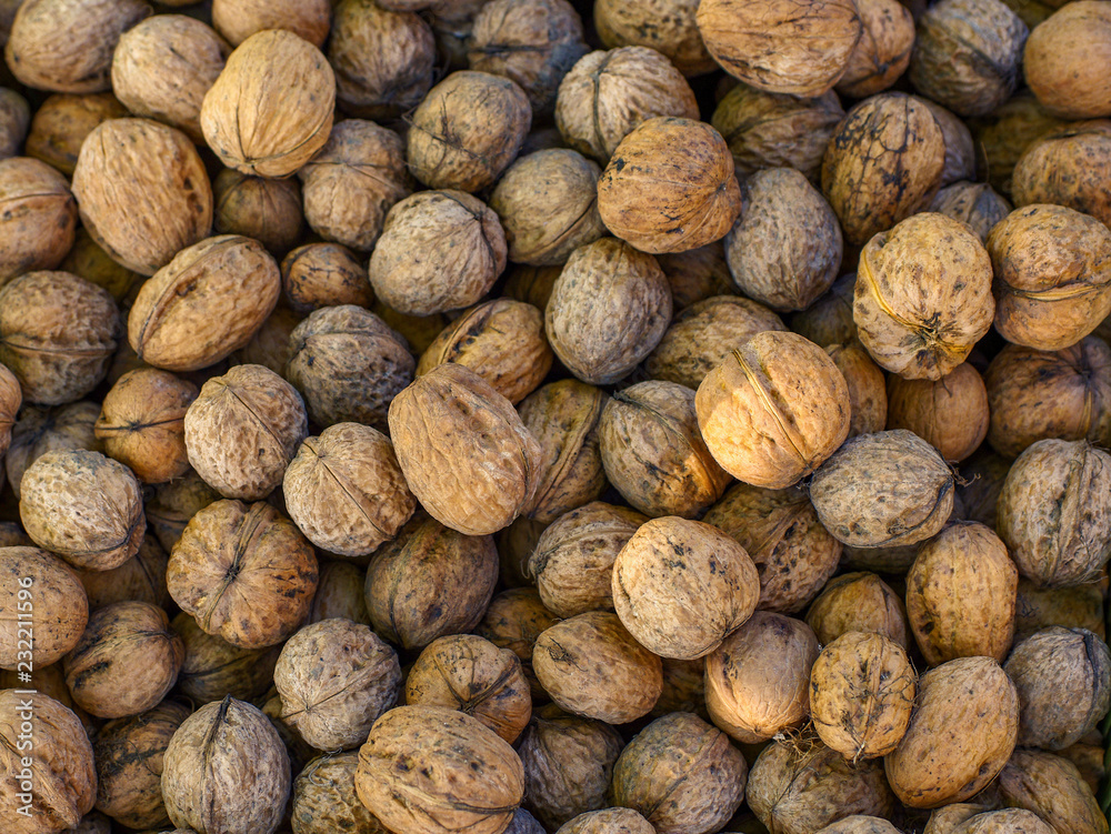 Top view of whole walnuts as background texture Top view of whole walnuts as background texture