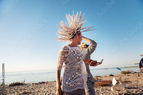 Near river. Appealing stylish woman with white dreadlocks dancing with her man near the river