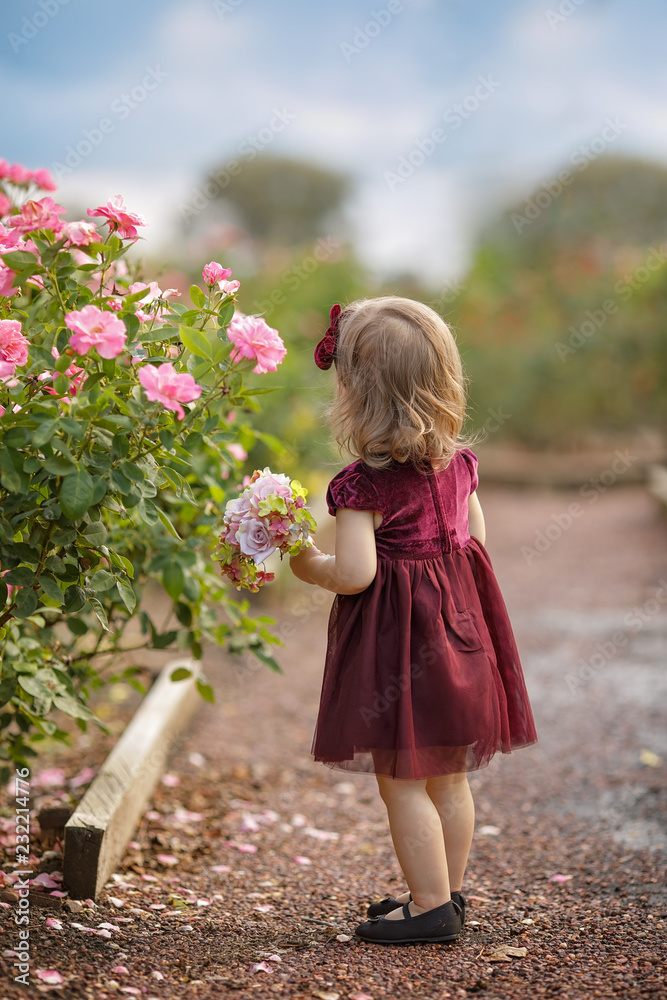 happy little girl in a flower garden happy little girl in a flower garden