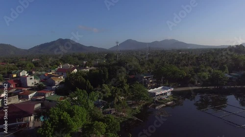 Sampaloc Lake, Settlements, Trees and vegetation along mountain lake shore. Drone aerial photo