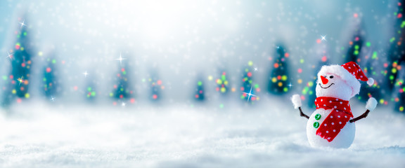 Happy Snowman In Winter Wonderland With Trees Lights And Falling Snow