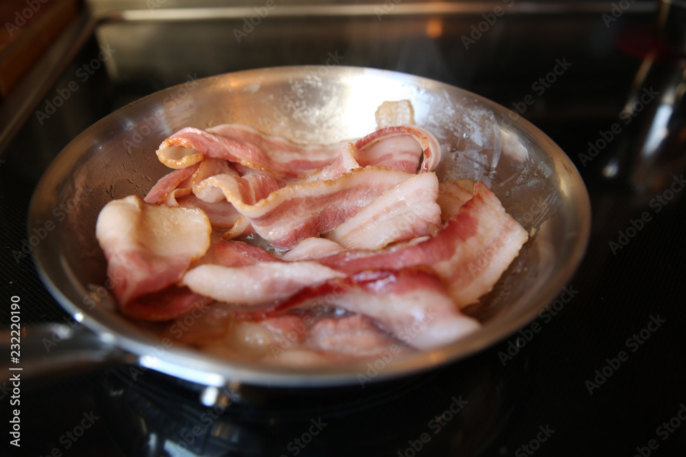 frying pan with fried bacon on the stove frying pan with fried bacon on the stove