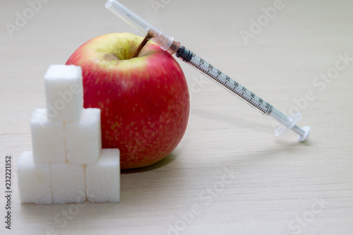 Sugar and apple with syringe photo