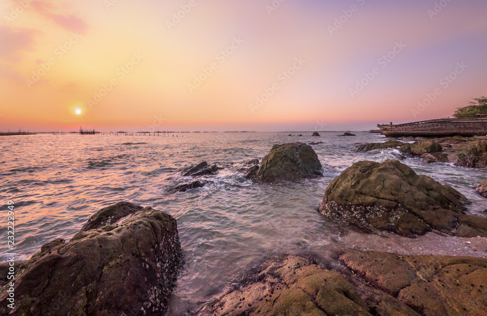 Rocks and sea in twilight time of somewhere in Chon Buri province at Thailand RA