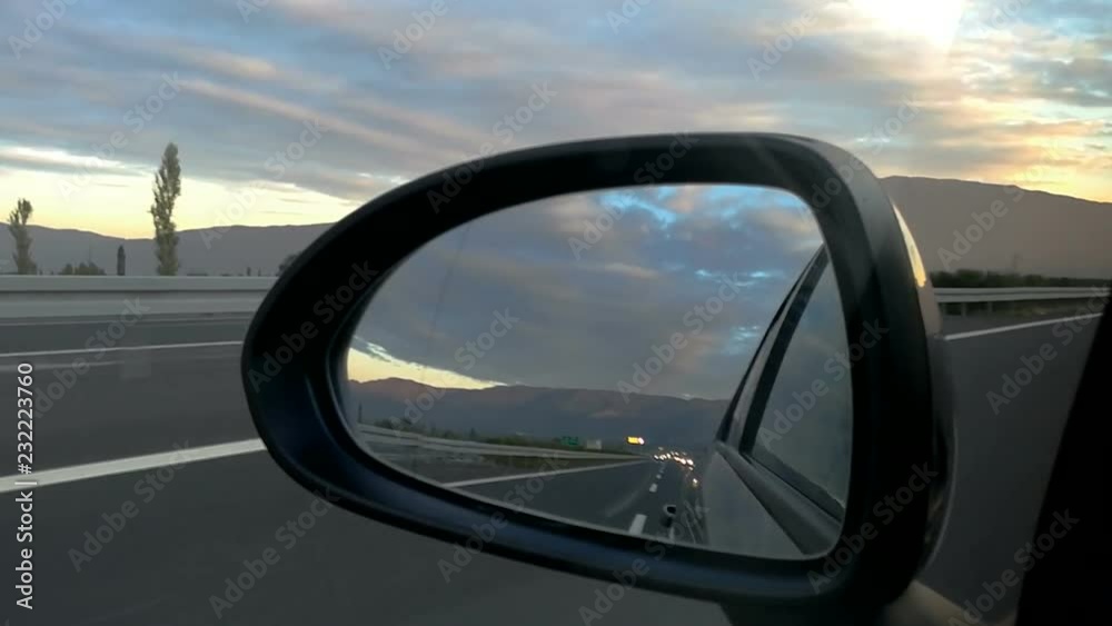 Highway view from car rear view mirror Highway view from car rear view mirror